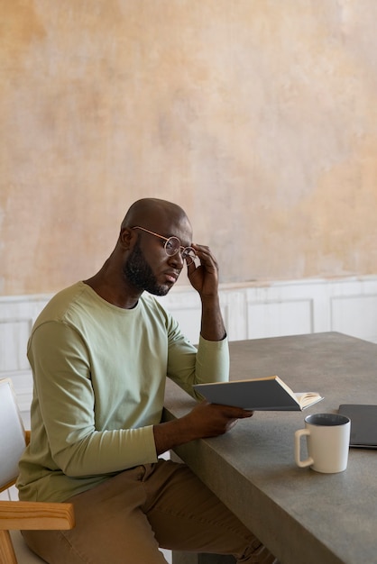 Medium shot man reading indoors