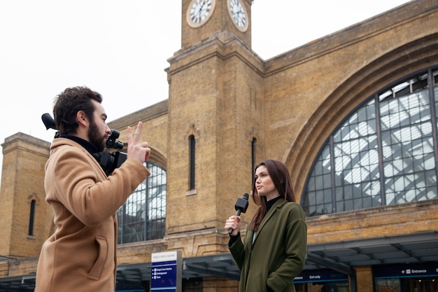 Medium shot man recording woman