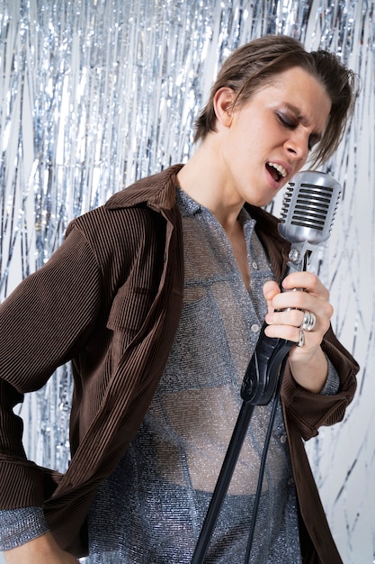 Medium shot man singing with microphone