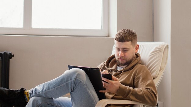 Medium shot man sitting on chair