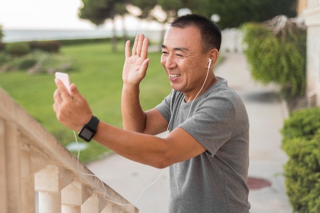 Medium shot man smiling and waving