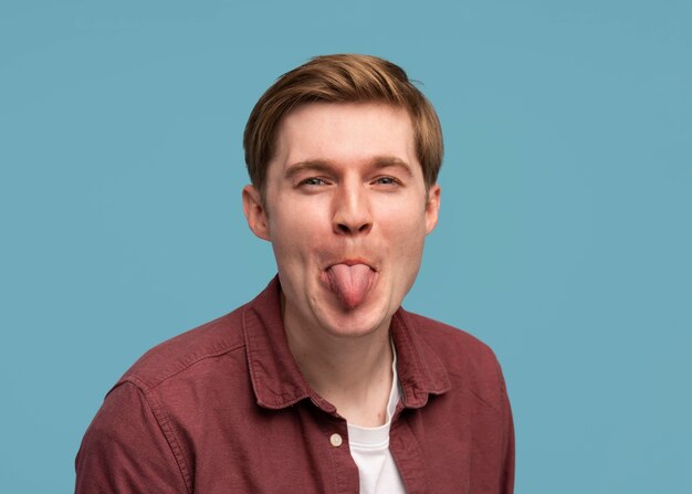 medium shot man sticking out the tongue