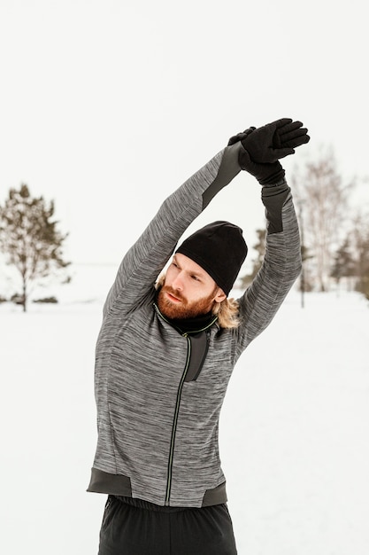 Medium shot man stretching arm