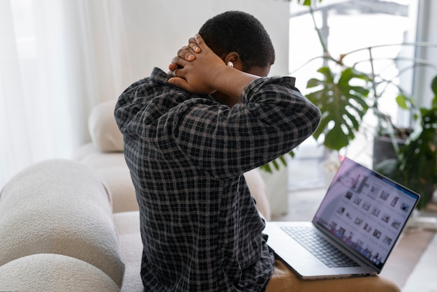 Free photo medium shot man stretching at home