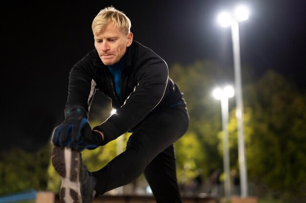 Medium shot man stretching leg