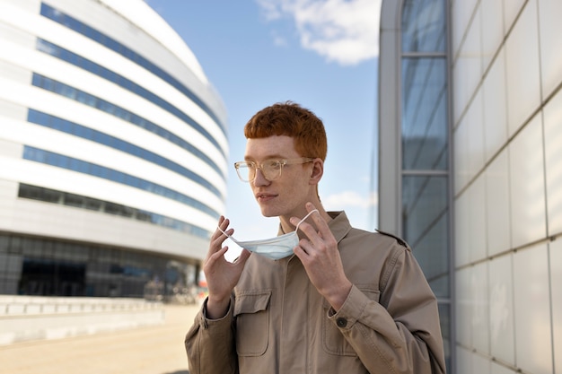 Medium shot man taking mask off