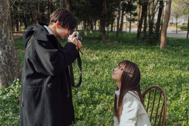 Medium shot man taking photos of woman