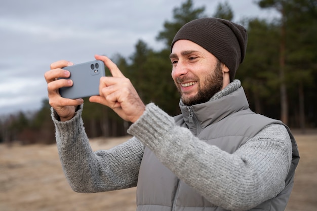 Medium shot man taking photos