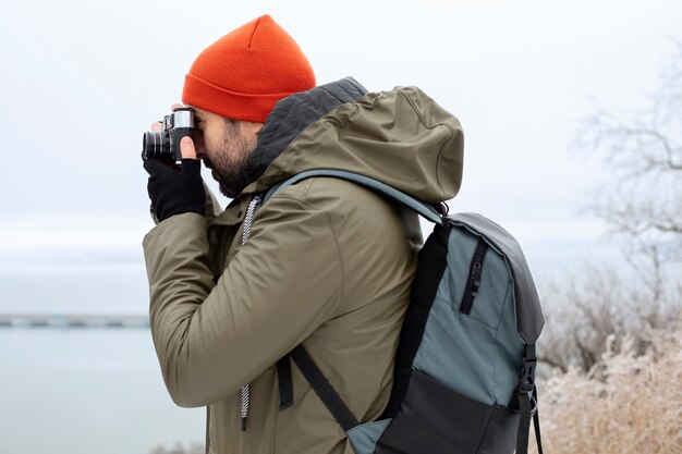 Medium shot man taking photos