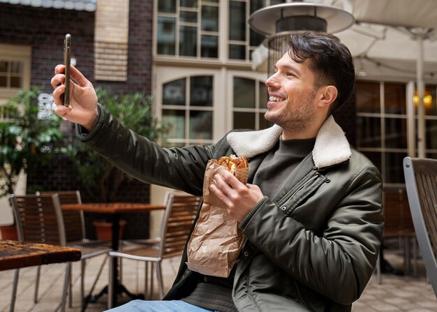 Medium shot man taking selfie