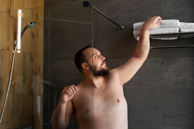 Free photo medium shot man taking shower