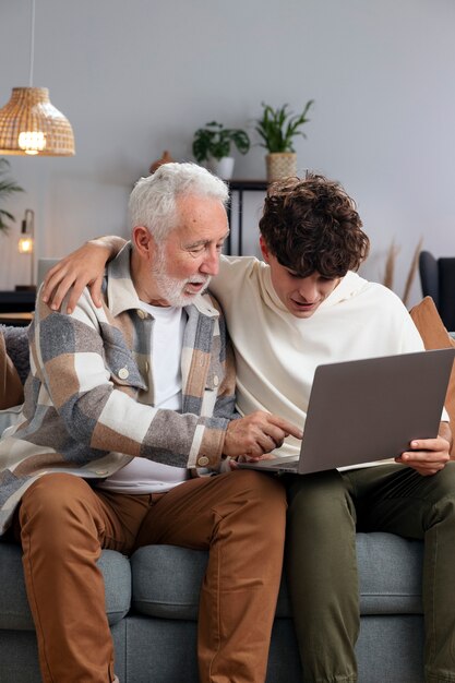 Medium shot man and teen holding laptop