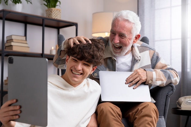 Medium shot man and teen with devices