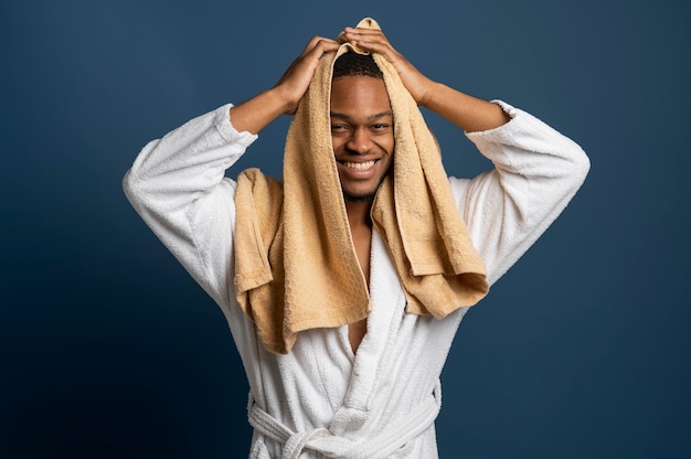 Free photo medium shot man using towel