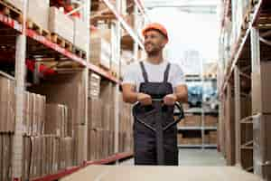 Free photo medium shot man walking in warehouse