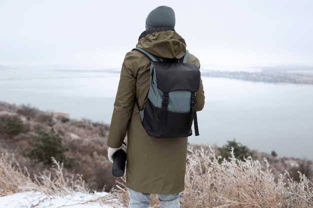 Free photo medium shot man wearing backpack