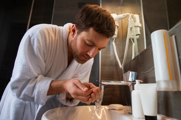 Medium shot man wearing bathrobe