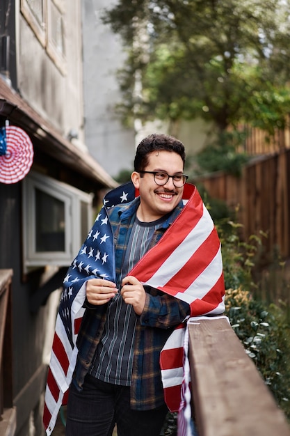 Free photo medium shot man wearing flag