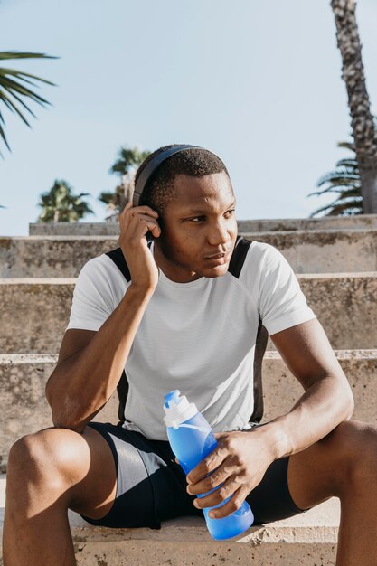 Medium shot man wearing headphones