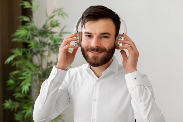 Free photo medium shot man wearing headphones