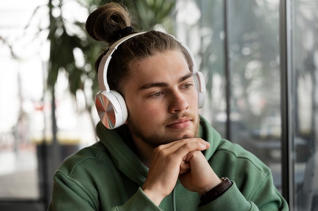 Medium shot man wearing headphones