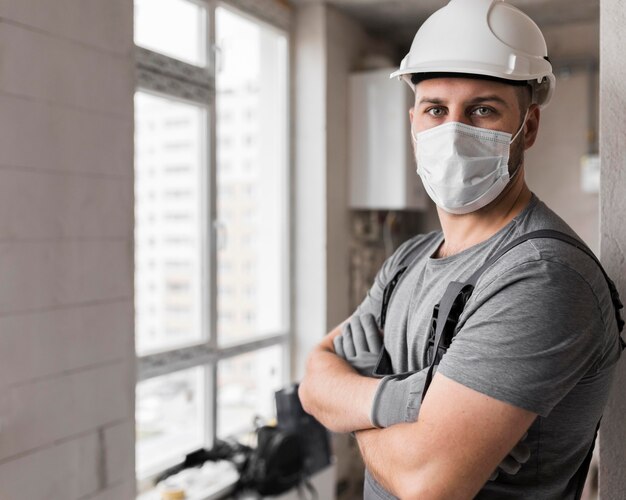 Medium shot man wearing mask and helmet