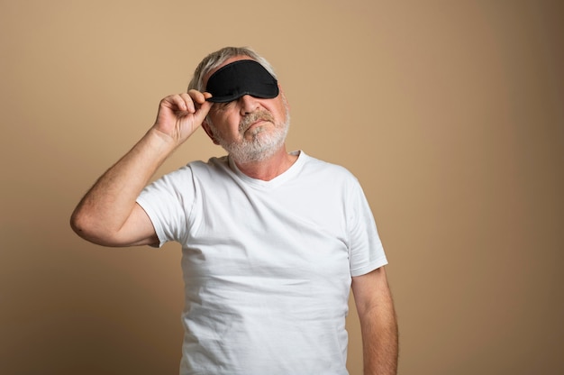 Medium shot man wearing sleep eye mask