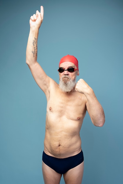 Medium shot man wearing swim cap