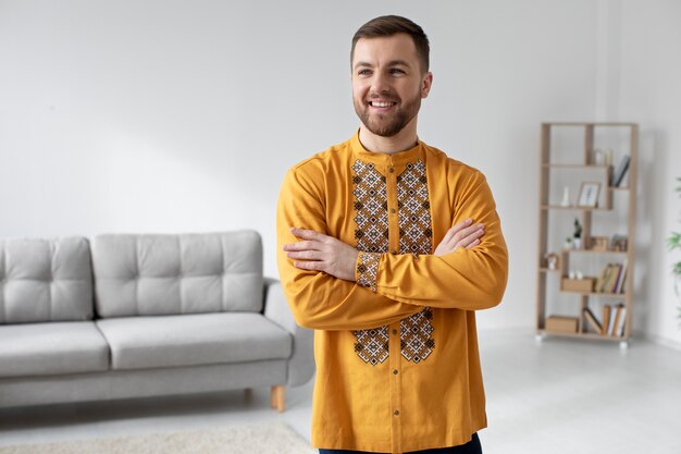 Medium shot man wearing ukranian shirt