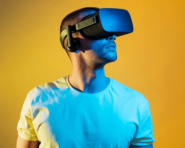 Medium shot man wearing virtual reality gadget