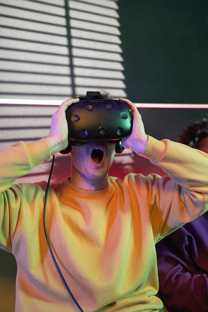 Medium shot man wearing vr glasses