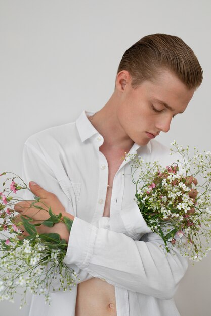 Medium shot man with flowers posing