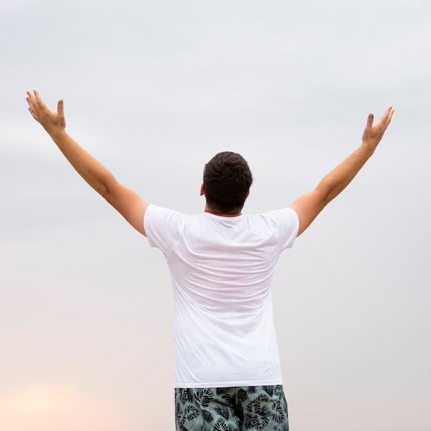 Free photo medium shot of a man with his arms in the air