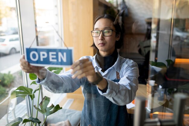 Medium shot man with open sign