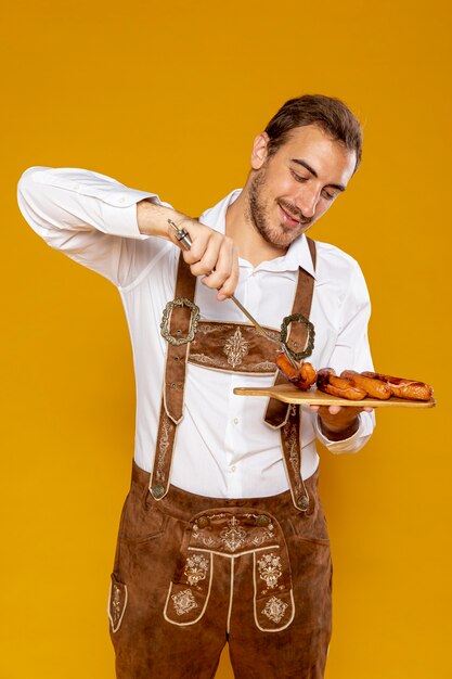 Medium shot of man with sausages tray