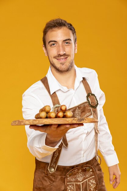 Medium shot of man with sausages tray