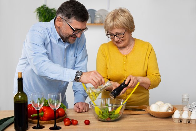 Medium shot man and woman cooking in kitchen