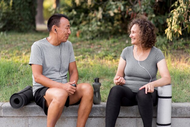 Medium shot man and woman sitting