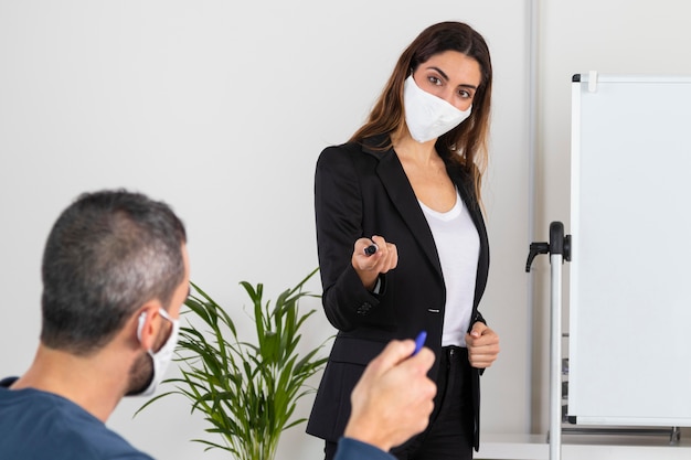 Free photo medium shot man and woman with masks