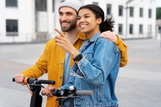 Free photo medium shot man and woman with scooters