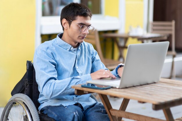 Medium shot man working on laptop