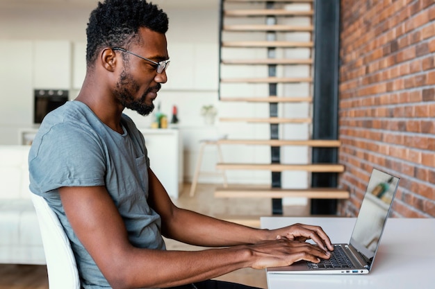 Medium shot man working on laptop