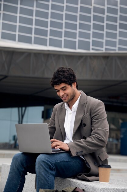 Medium shot man working on laptop