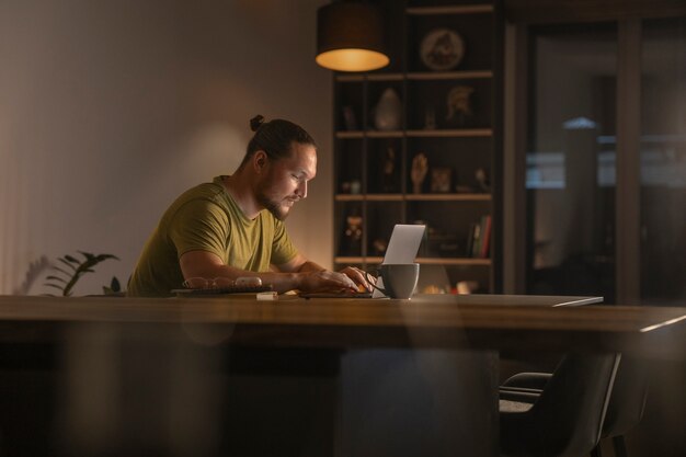 Medium shot man  working late at night