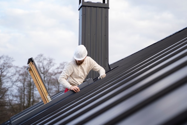 Free photo medium shot man working on roof