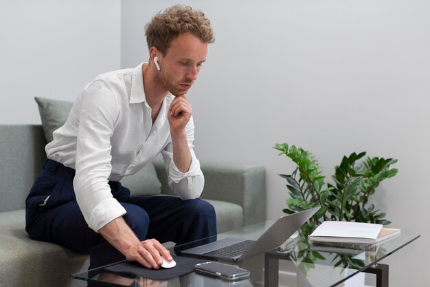 Medium shot man working with laptop