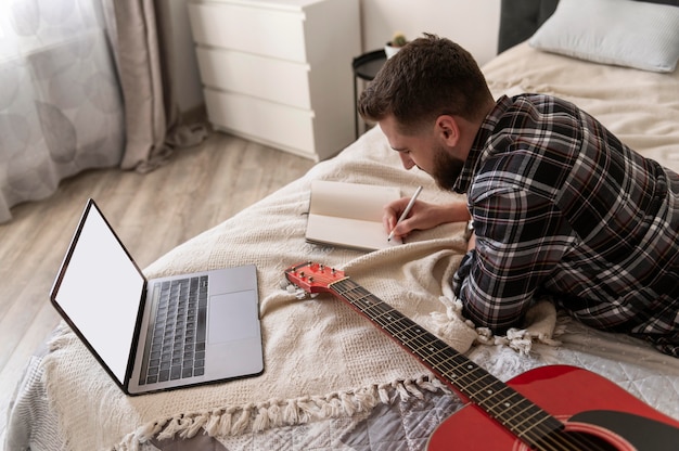 Medium shot man writing lyrics