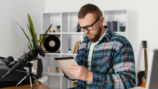 Medium shot man writing on notebook