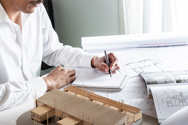 Free photo medium shot of man writing with his left hand