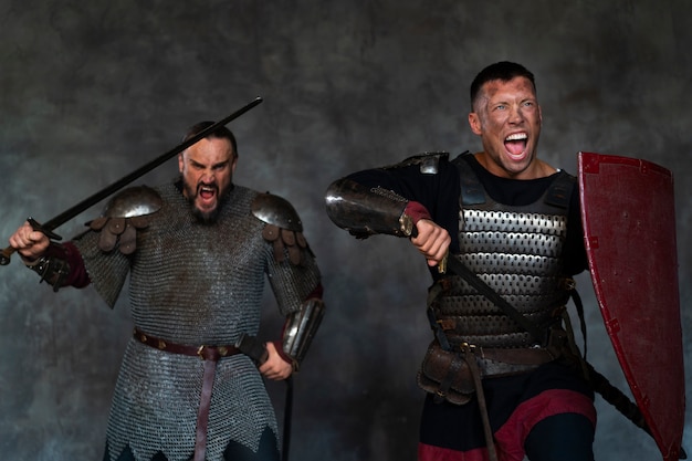 Free photo medium shot medieval soldiers posing in studio